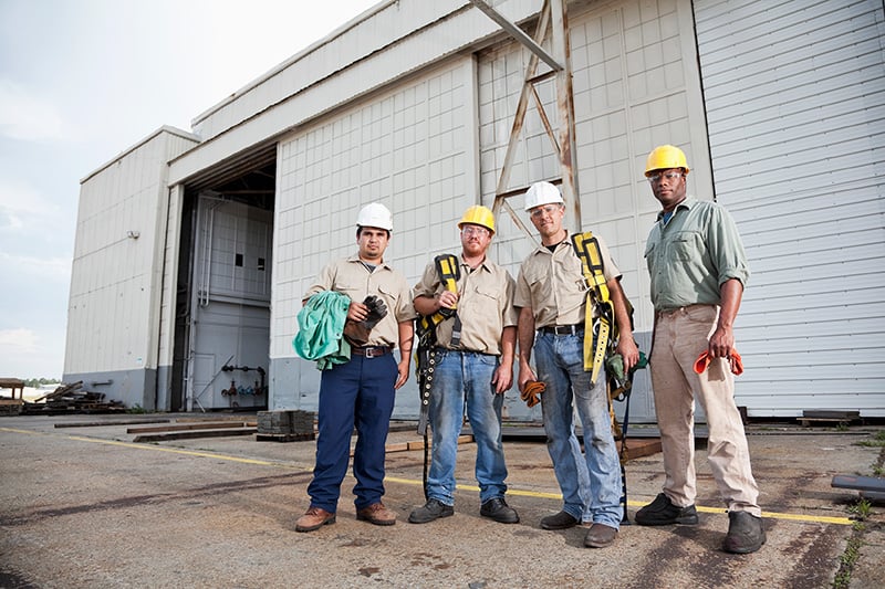 workers-equipped-with-safety-gear-facing-camera workers-equipped-with-safety-gear-facing-camera