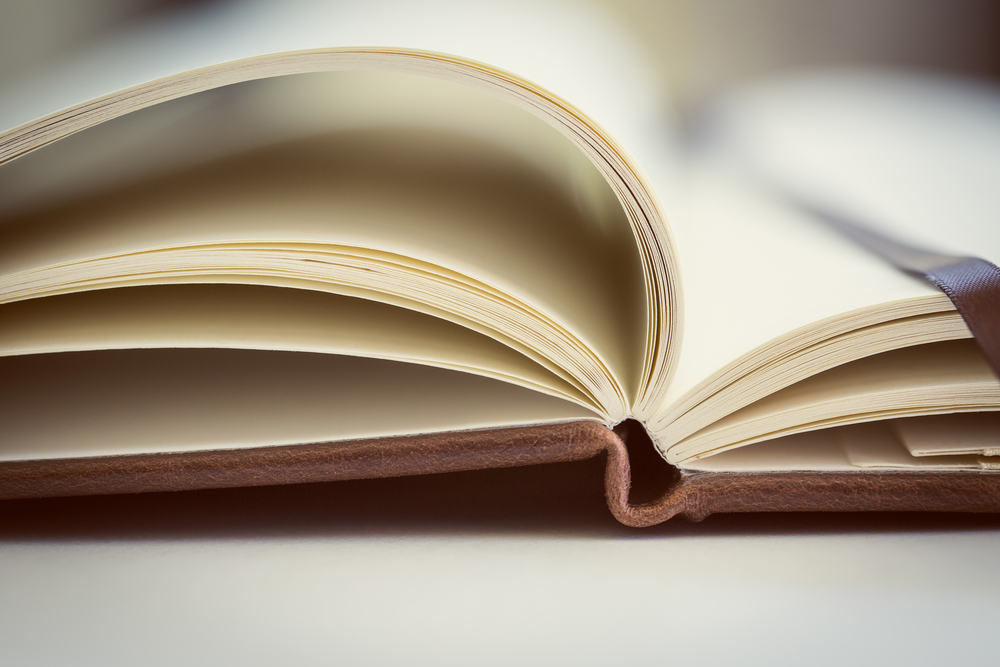 Opened book on the table. Close up. Opened book on the table. Close up.