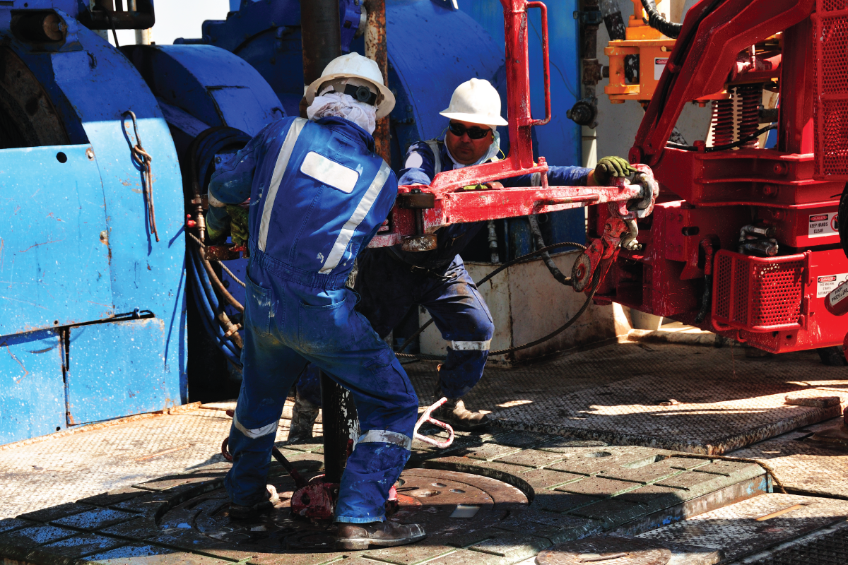 workers-adjusting-machine-on-oil-rig